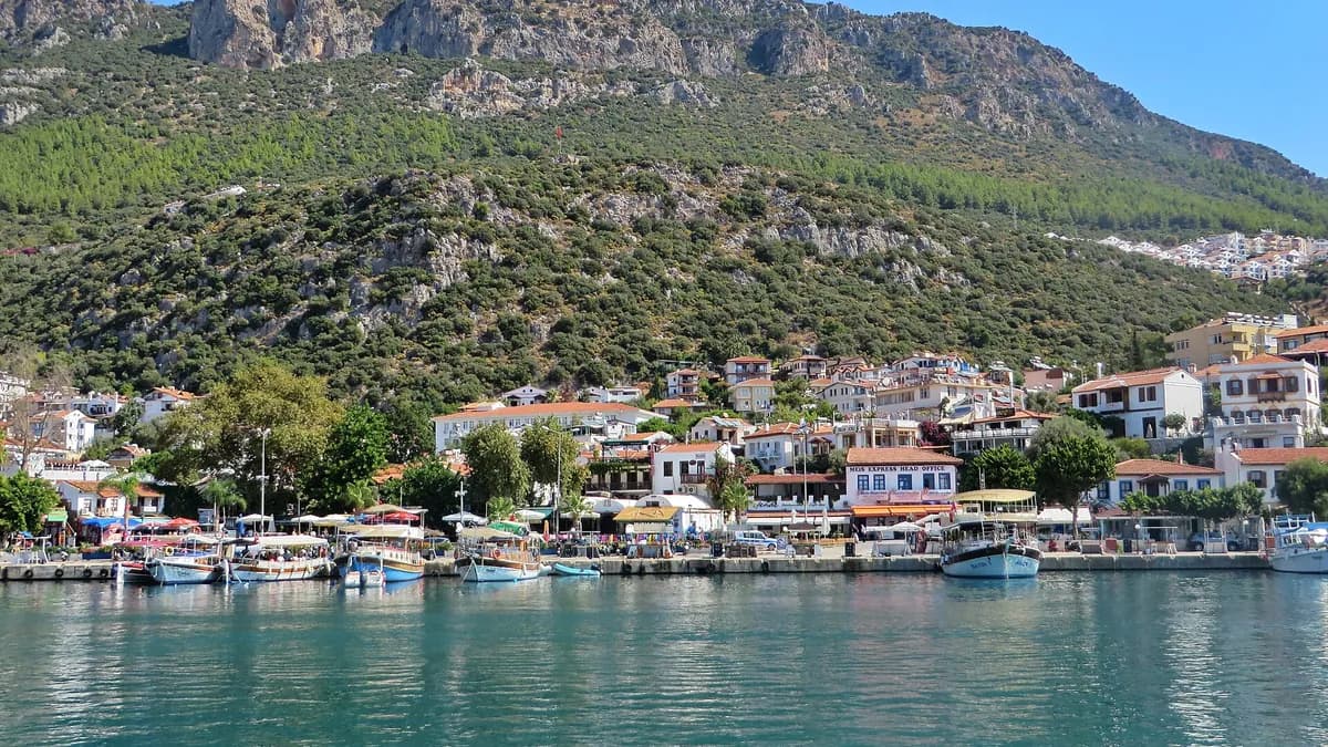 Solo female gezgin exploring Antalya old harbor with traditional boats and harbor walls